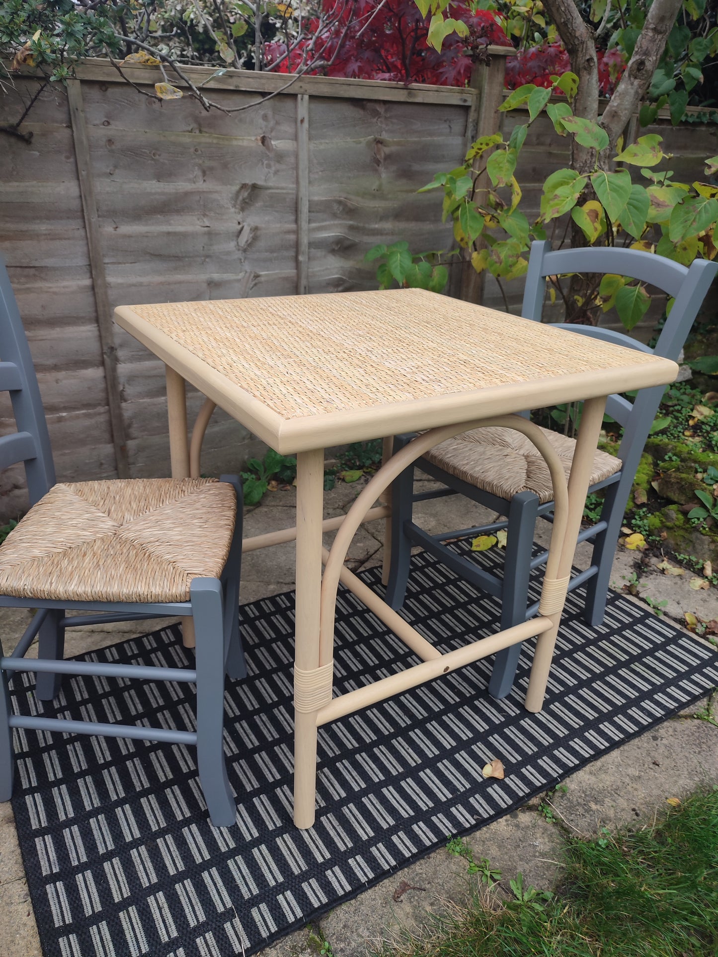 A cane and rubberwood bistro table