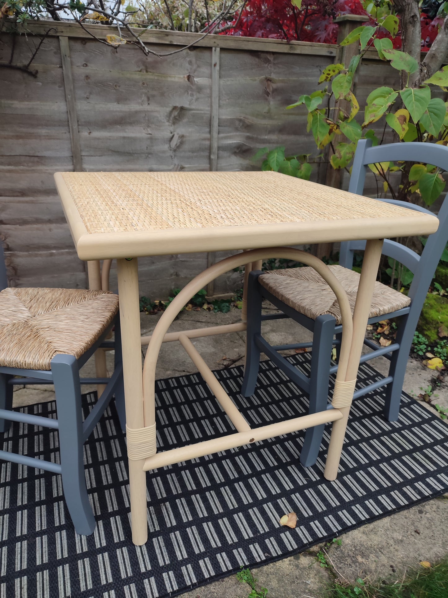 A cane and rubberwood bistro table
