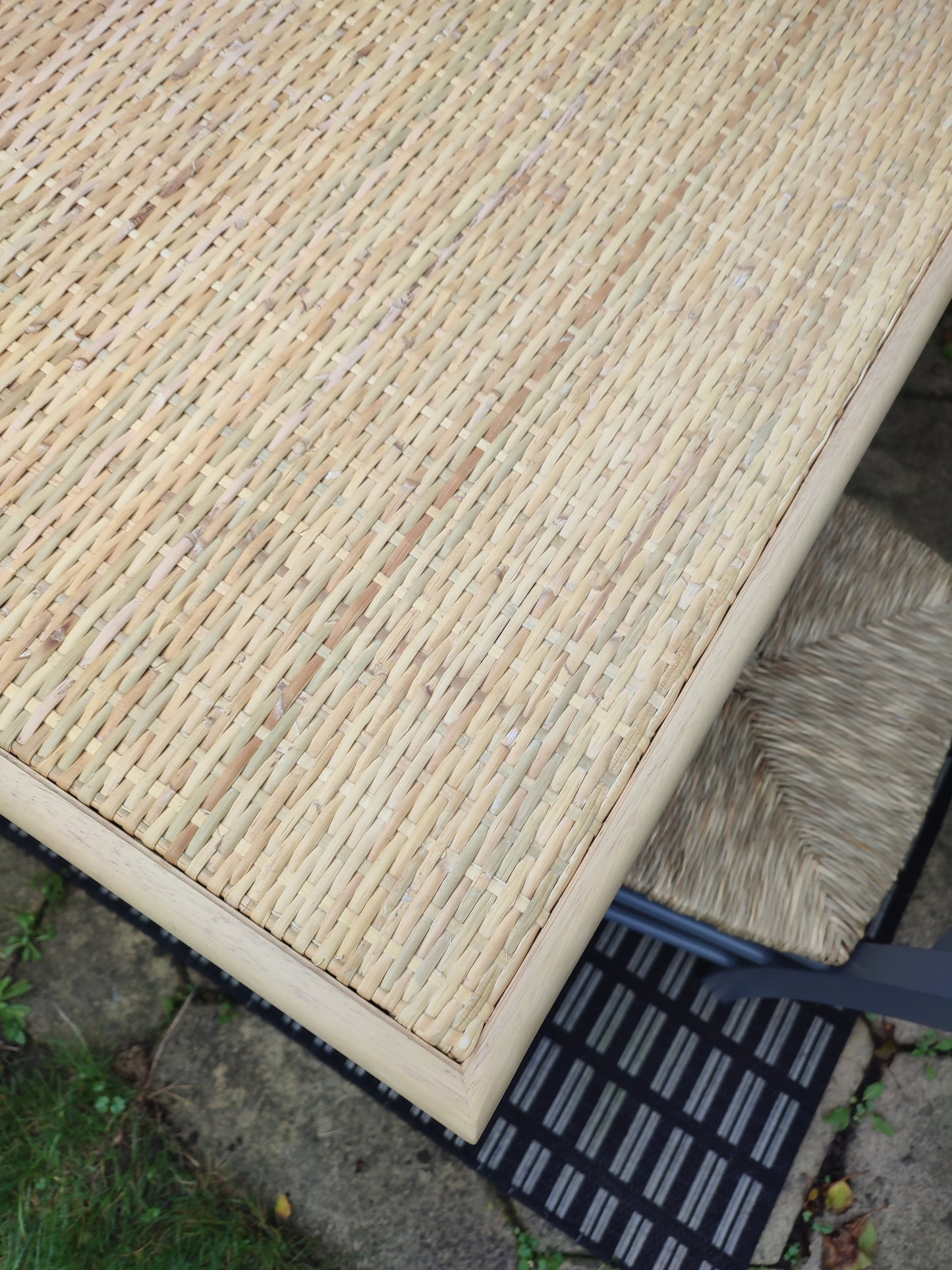 A cane and rubberwood bistro table