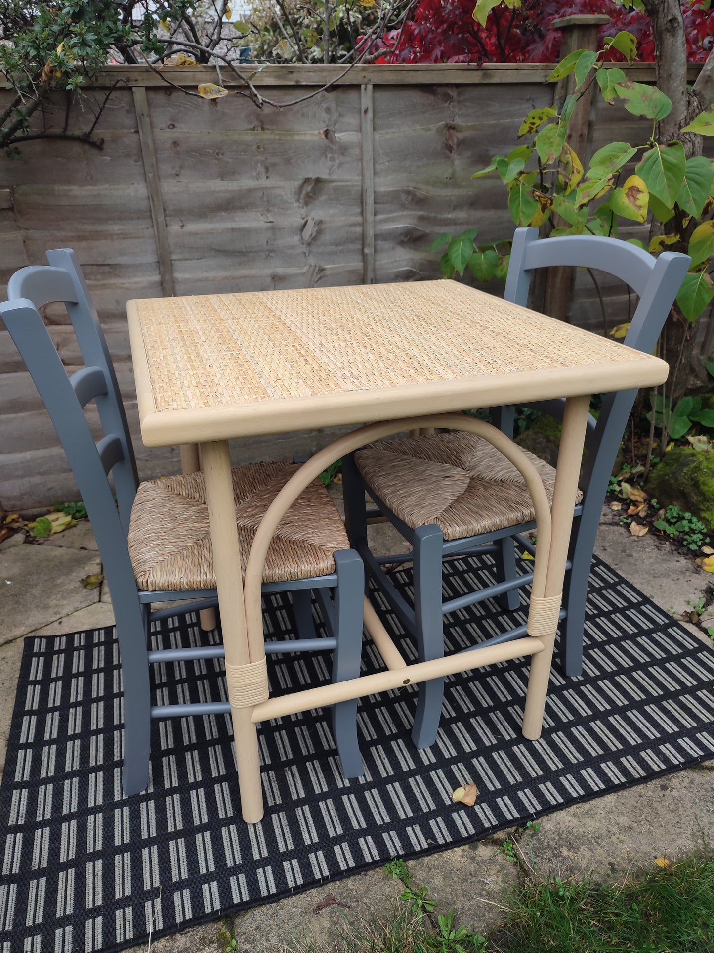 A cane and rubberwood bistro table
