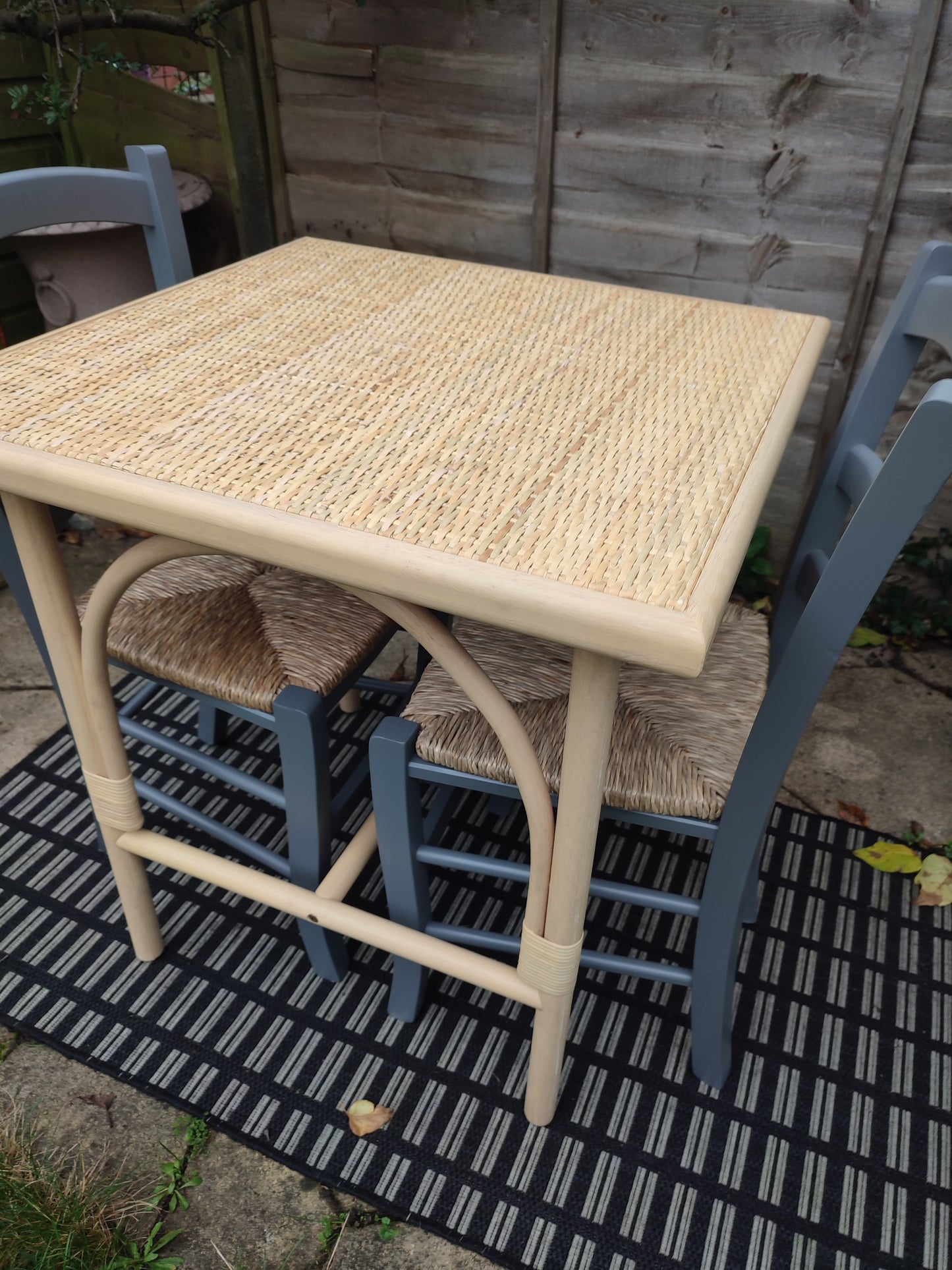 A cane and rubberwood bistro table