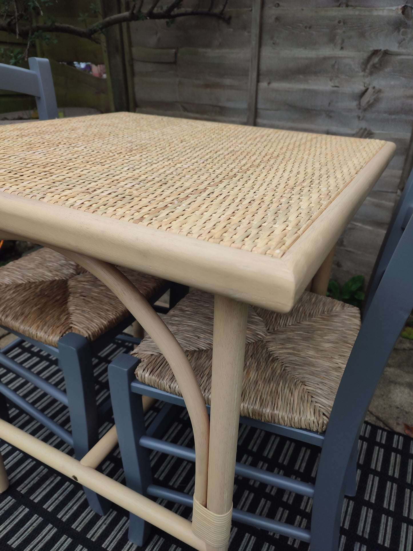 A cane and rubberwood bistro table